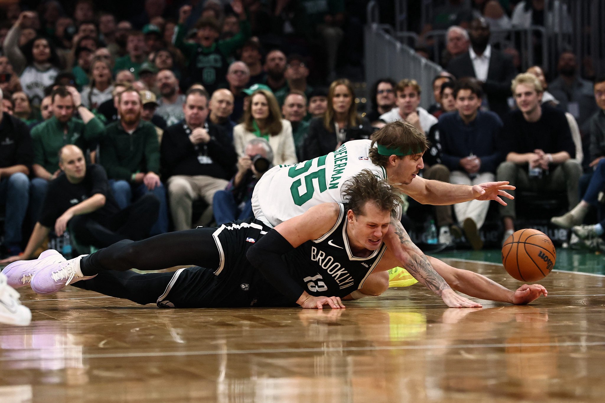 Oct 27, 2026; Boston, Massachusetts, USA; Brooklyn Nets center Moritz Wagner (13) and Boston Celtics guard Baylor Scheierman (55) battle for a loose ball during the second half at TD Garden. Mandatory Credit: Winslow Townson-Imagn Images