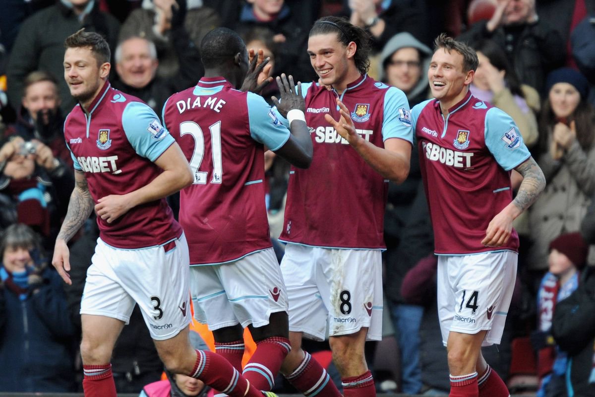 LONDON, ENGLAND - MARCH 30:  Andy Carroll of West Ham United (C) celebrates scoring his second goal and his team's third with teammates Mohamed Diame (second left) and Matthew Taylor (R)  during the Barclays Premier League match between West Ham United and West Bromwich Albion at the Boleyn Ground on March 30, 2013 in London, England.  (Photo by Steve Bardens/Getty Images)
