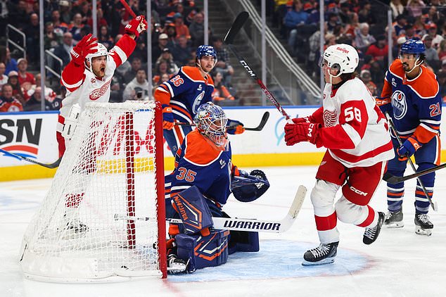 Edmonton Oilers goaltender Tristan Jarry (35) reacts as Detroit Red Wings' Viktor Arvidsson (33) and Emmitt Finnie (58) celebrate Finnie's goal during third period NHL hockey action in Edmonton, Alberta, Monday, Oct. 26, 2026. (Codie McLachlan/The Canadian Press via AP)