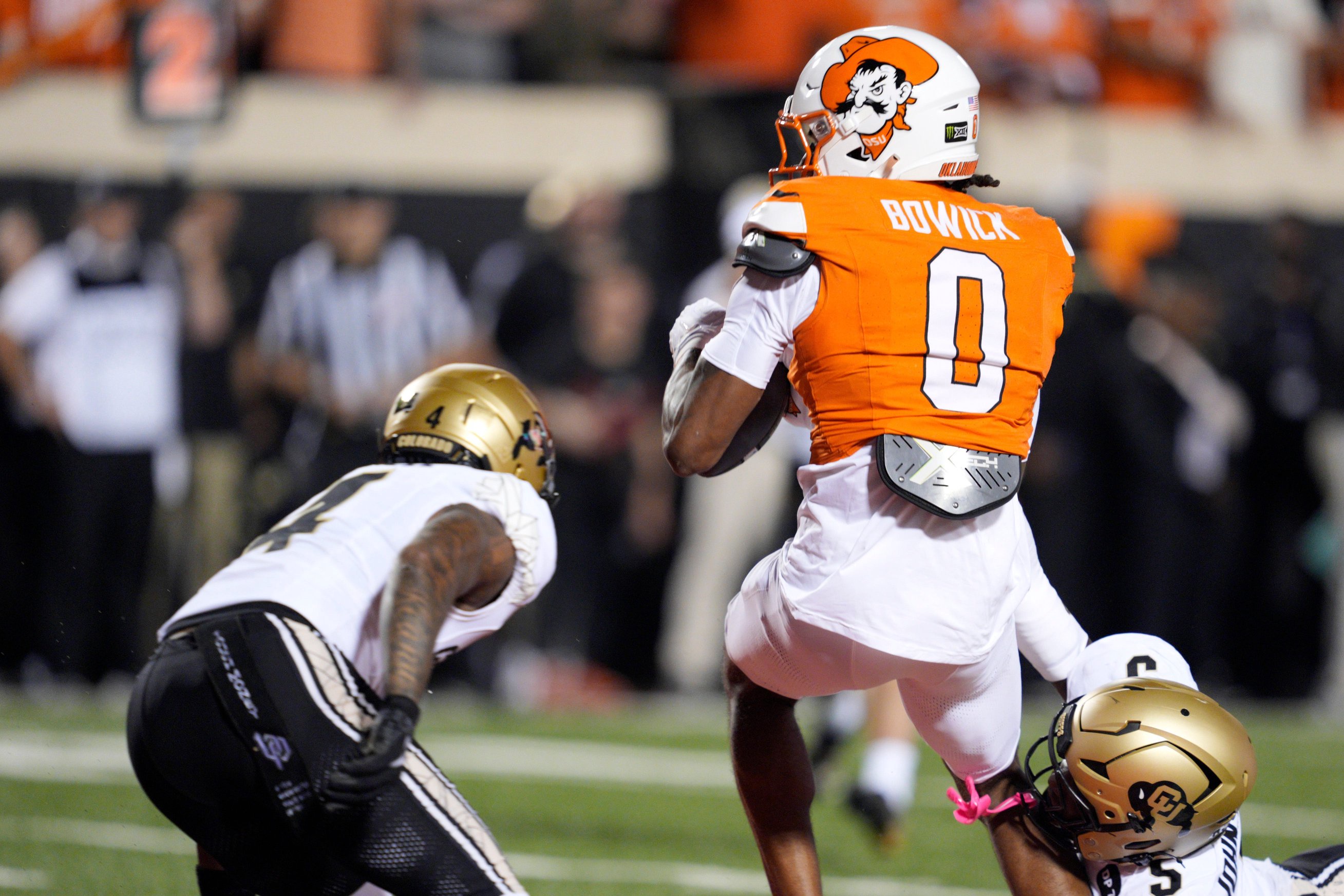 Oklahoma State Cowboys wide receiver Justin Bowick (0) scores a touchdown as Colorado Buffaloes defensive back RJ Johnson (5) tries to bring him down during a college football game between the Oklahoma State Cowboys (OSU) and the Colorado Buffaloes at Boone Pickens Stadium in Stillwater, Okla., Saturday, Oct. 24, 2026.