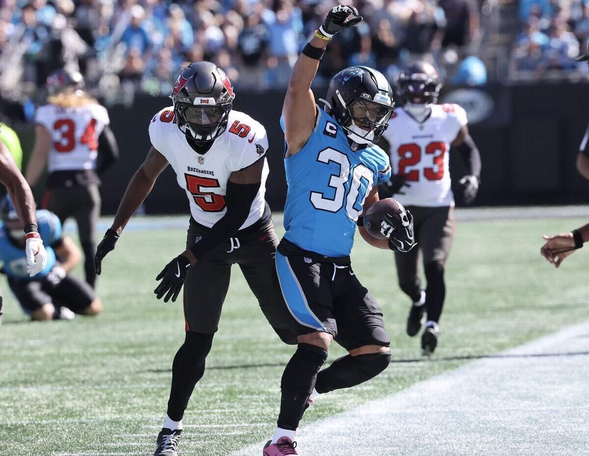 Carolina Panthers runningback Chuba Hubbard steps out of bounds next to Tampa Bay safety Ifeatu Melifonwu during the first half of the game Sunday, Oct. 23, 2026 at Bank of America Stadium in Charlotte.