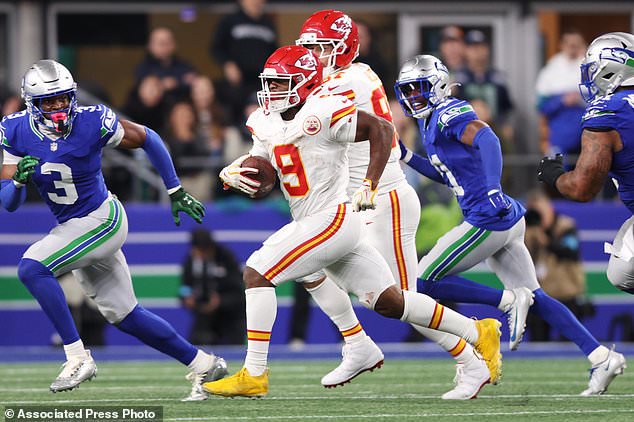 Kansas City Chiefs running back Kenneth Walker III (9) runs the ball during the second half of an NFL football game against the Seattle Seahawks in Seattle, Sunday, Oct. 25, 2026. (AP Photo/Kevin Ng)