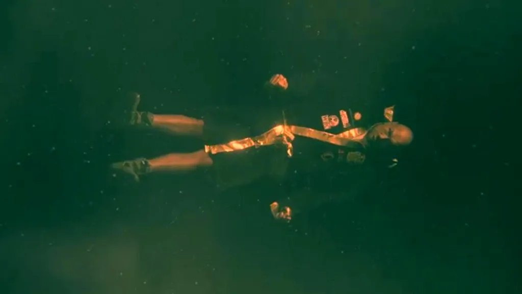 Tyson Fury floating underwater in boxing gear.
