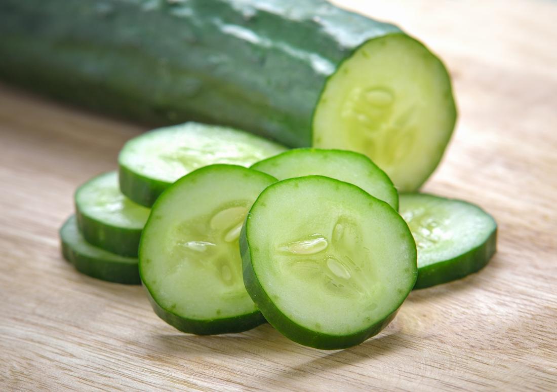Cucumber slices on wooden surface
