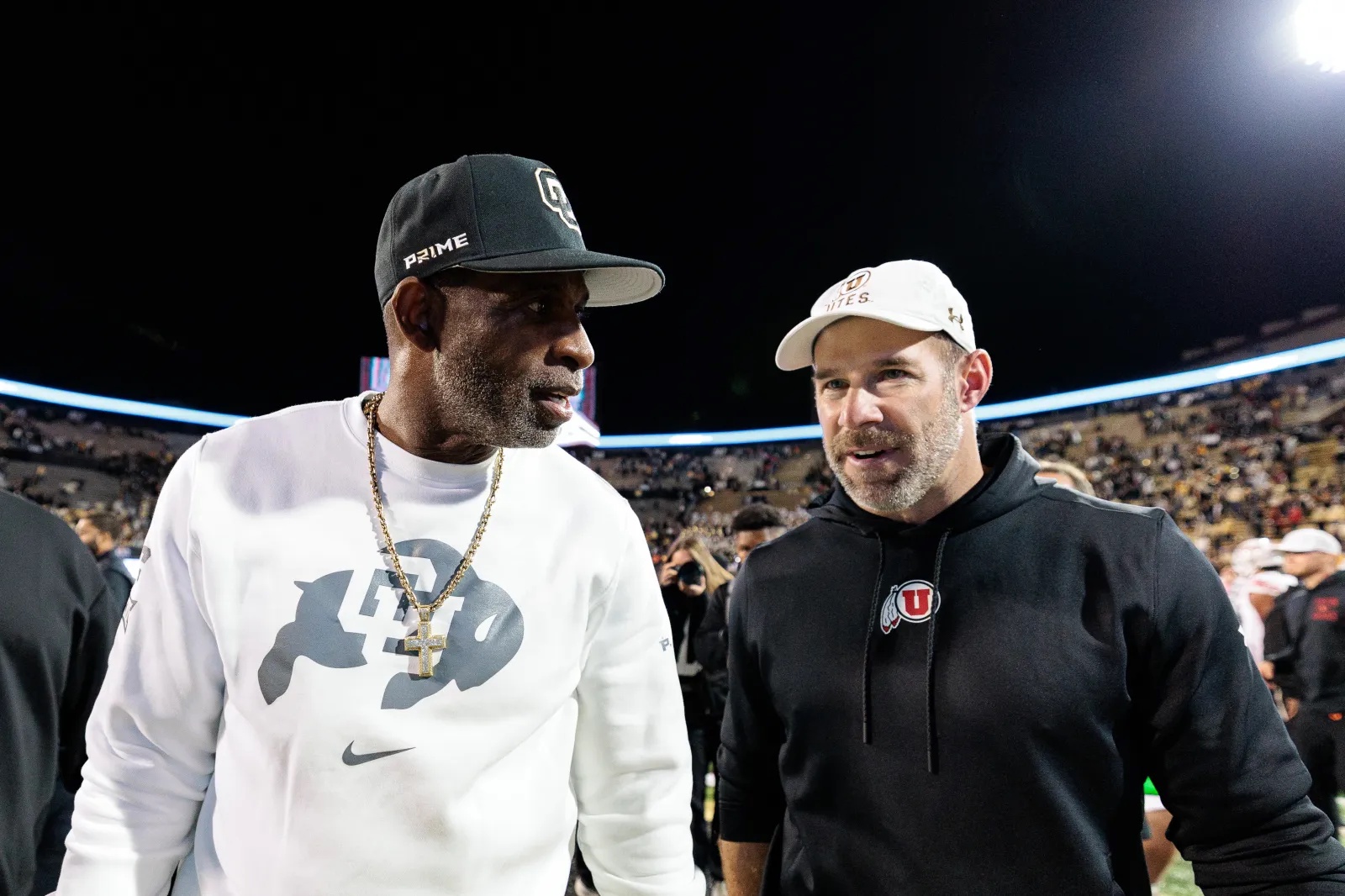 Colorado head coach Deion Sanders talks to Utah head coach Morgan Scalley after Buffaloes loss