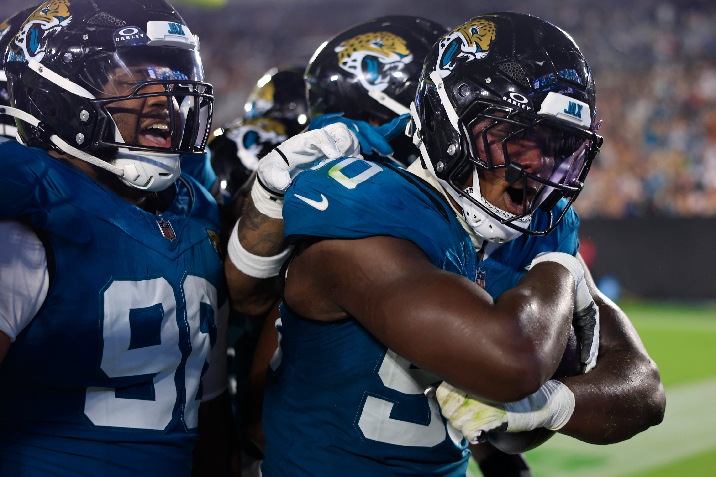 Jacksonville Jaguars defensive end Wesley Williams (90) celebrates his fumble turnover with defensive tackle Jalen Hunt (96), left, and others during the second quarter of an NFL preseason football game at EverBank Stadum on Friday, Aug. 28, 2026 in Jacksonville, Fla.