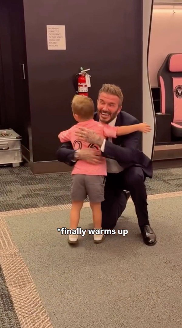 David Beckham hugs a young boy wearing an Inter Miami kit