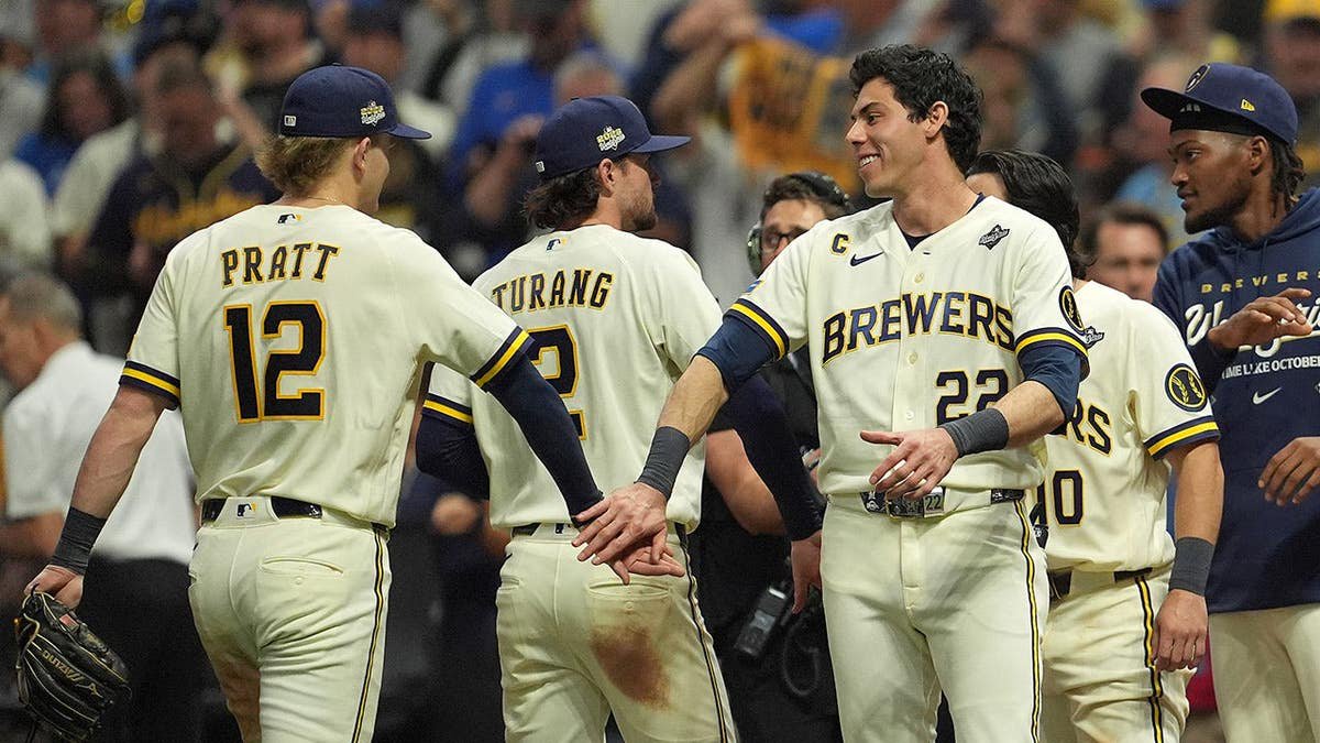 Cooper Pratt and Christian Yelich of the Milwaukee Brewers celebrate after defeating the Tampa Bay Rays.
