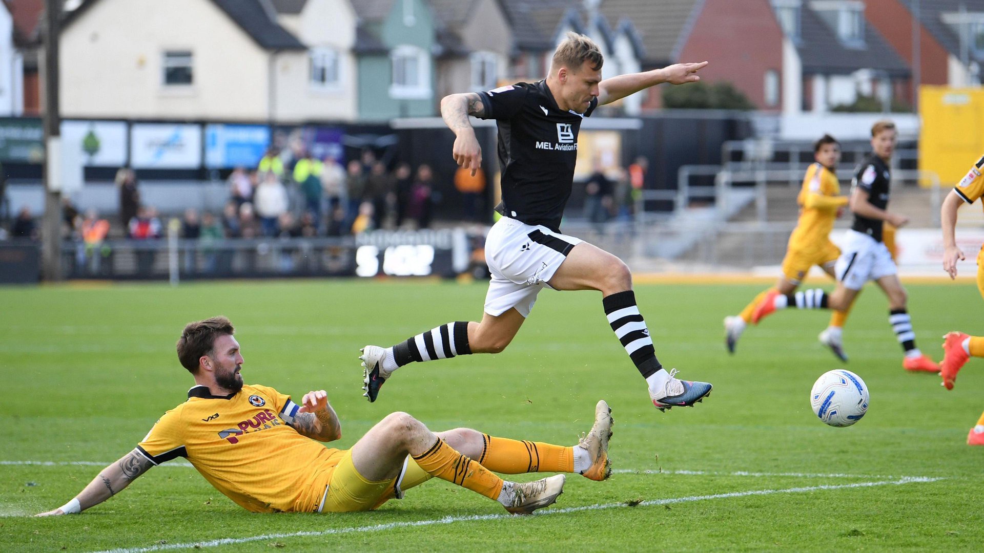 Kyle Cameron tackles Colchester United's Jack Tucker 