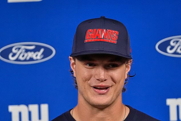 New York Giants quarterback J.J. McCarthy talks with reporters following an NFL football game against the Houston Texans in Houston, Sunday, Oct. 25, 2026. (AP Photo/Gerald Herbert)