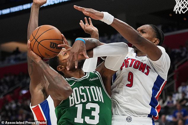 Boston Celtics forward Paul George (13) is fouled by Detroit Pistons forward Ausar Thompson (9) in the first half of an NBA basketball game in Detroit, Tuesday, Oct. 20, 2026. (AP Photo/Paul Sancya)