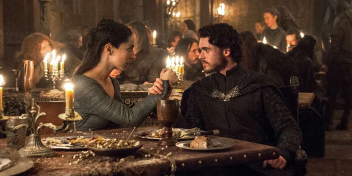 Robb Stark and his wife look at each other at the Red Wedding in Game of Thrones.