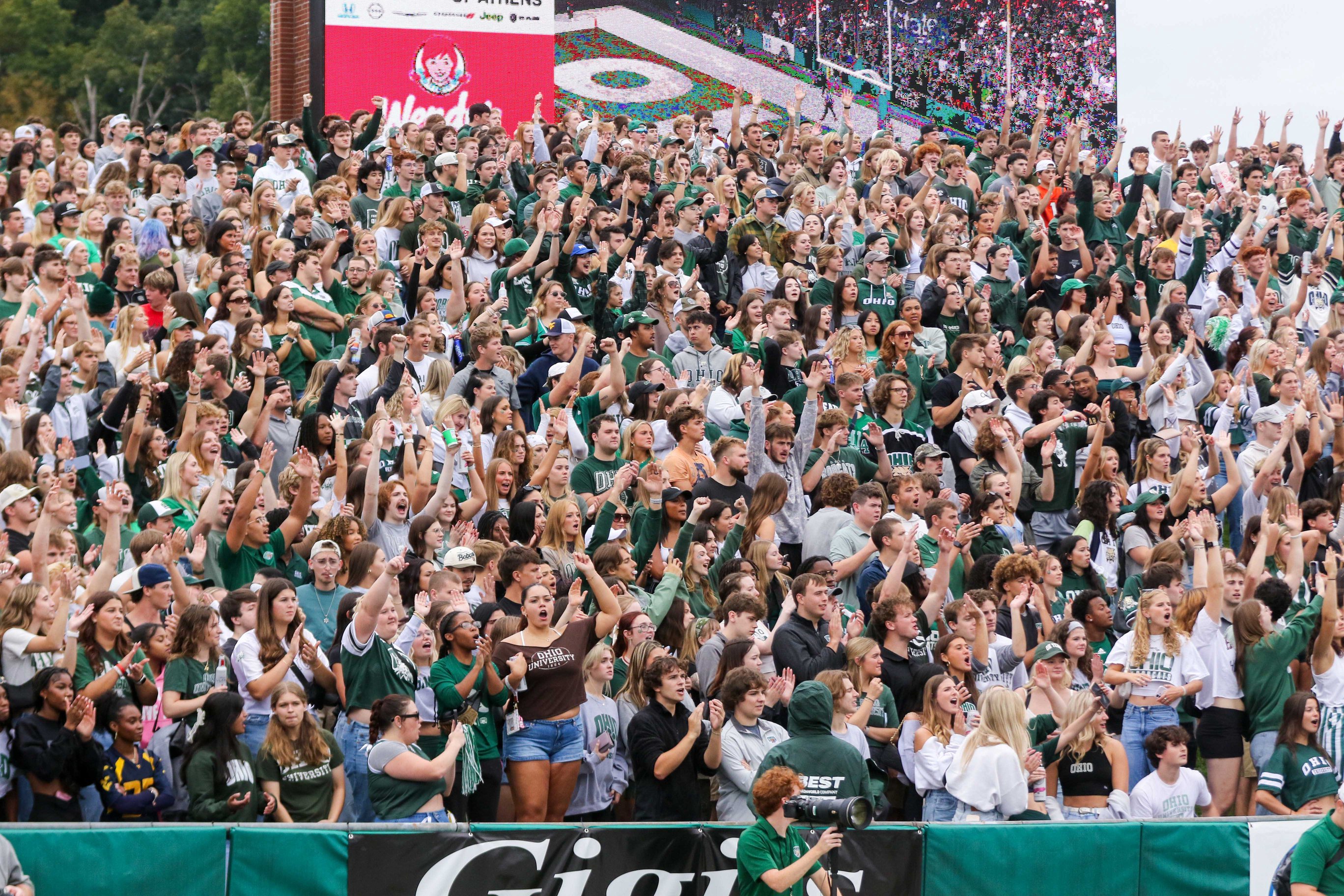 Sep 6, 2025; Athens, Ohio, USA; Ohio Bobcats fans cheer during the first quarter against the West Virginia Mountaineers at Peden Stadium. Mandatory Credit: Ben Queen-Imagn Images