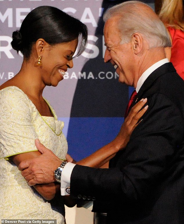 Michelle Obama is greeted by Sen. Joe Biden in the stands of the Pepsi Center during the second day of the Democratic National Convention on Tuesday, August 26, 2008 in Denver, Colorado