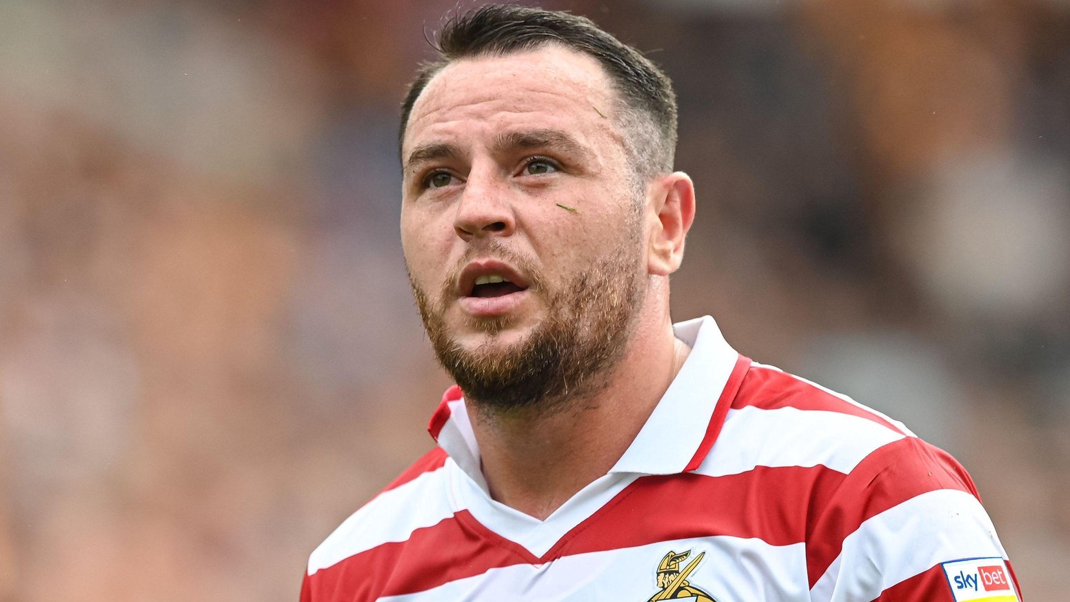 Lee Tomlin wearing a Doncaster red and white-striped jersey.