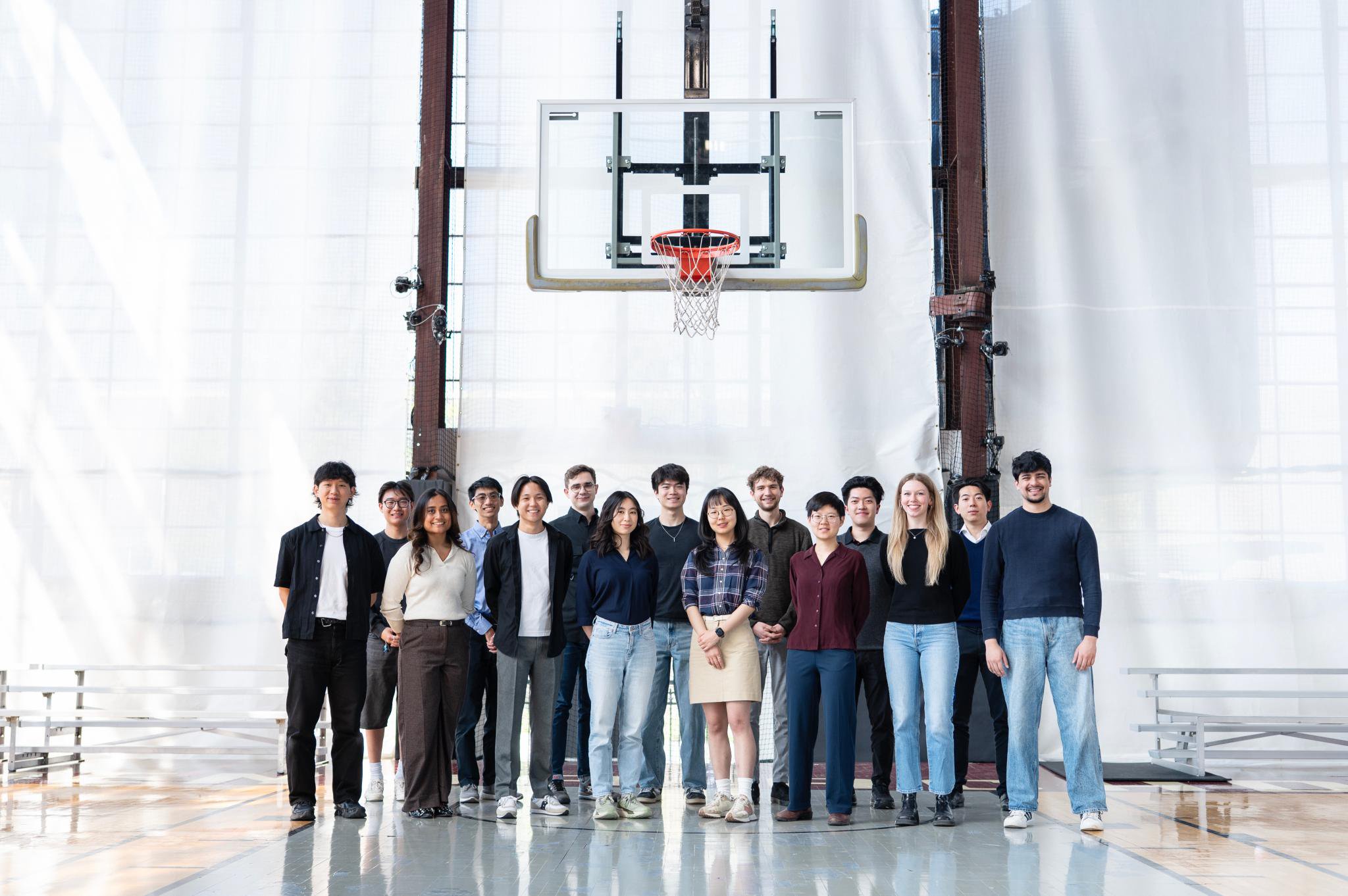 Group photo of Kelvin Cui and Peripheral team members standing in front of a basketball hoop.