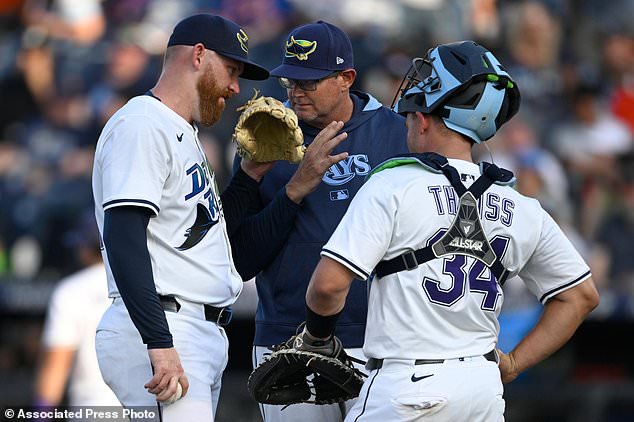 FILE - Tampa Bay Rays pitching coach Kyle Snyder, center, visits the mound with starting pitcher Zack Littell, left, and catcher catcher Matt Thaiss (34) during the first inning of a baseball game against the Baltimore Orioles, July 19, 2025, in Tampa, Fla. (AP Photo/Phelan M. Ebenhack, File)