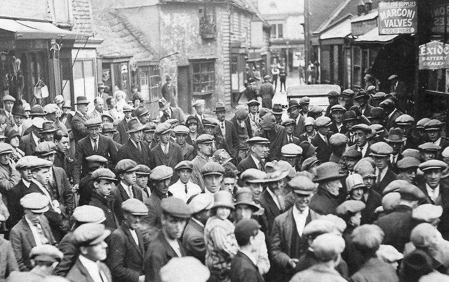 Newmarket's Market Street is packed as crowds gather outside Reginald Mace's wireless accessories shop to listen to Call Boy's Derby the first to be broadcast on radio