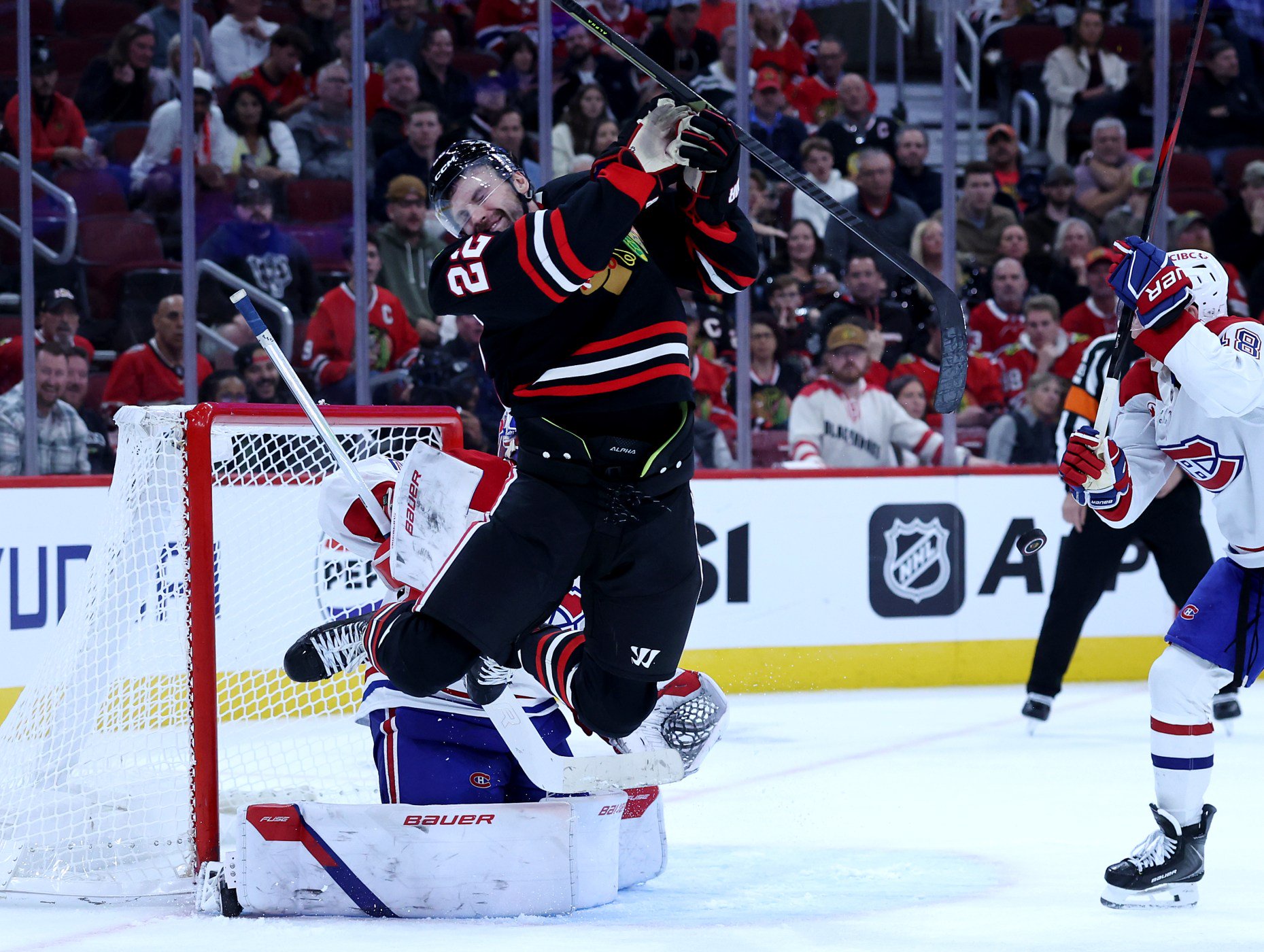 Chicago Blackhawks right wing Cole Smith (22) reacts after being hit in the face with a puck in the third period of a game against the Montréal Canadiens at the United Center in Chicago on Oct. 23, 2026. (Chris Sweda/Chicago Tribune)