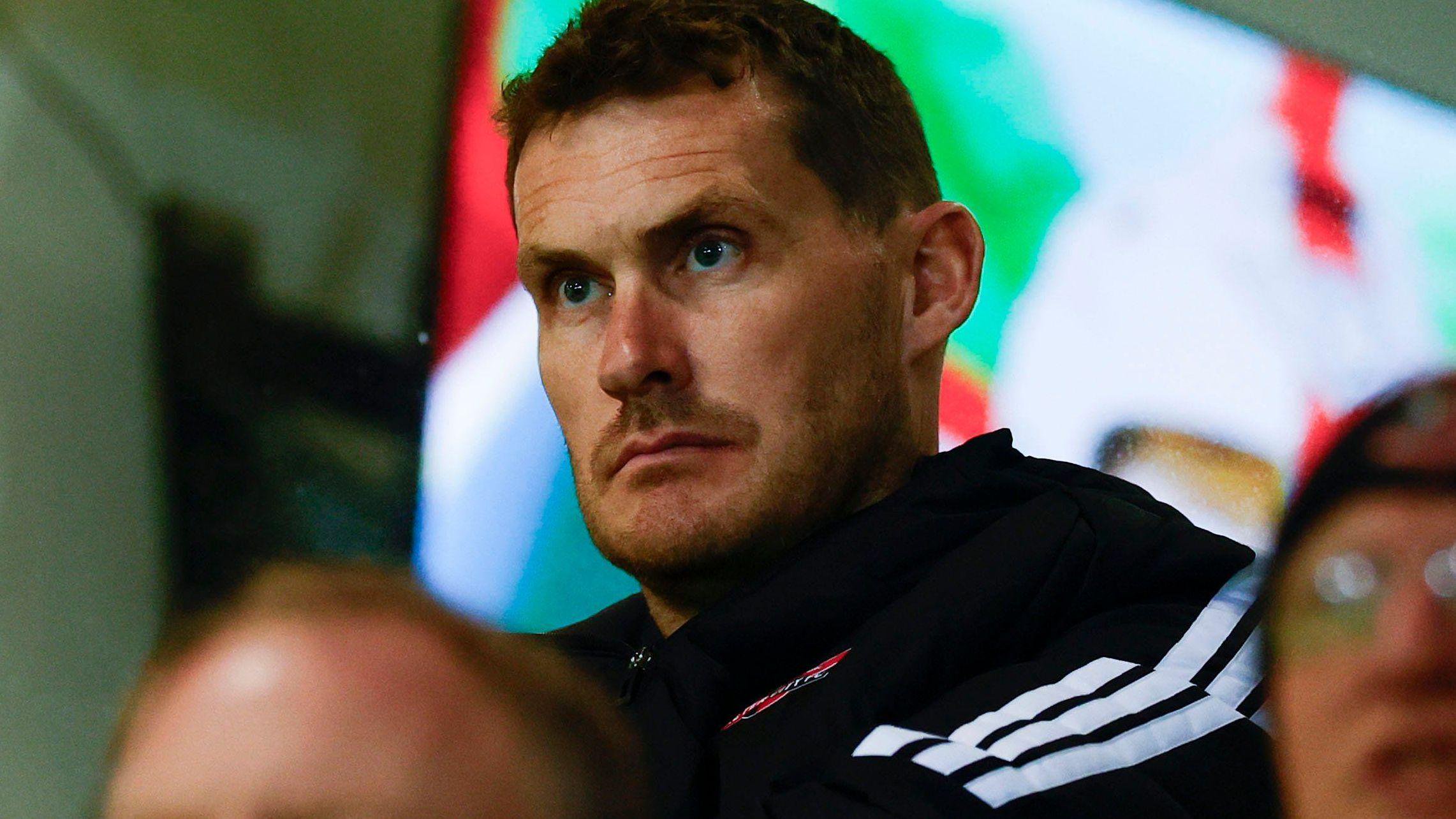 Matt Taylor wearing an Exeter City shirt and looking straight ahead.