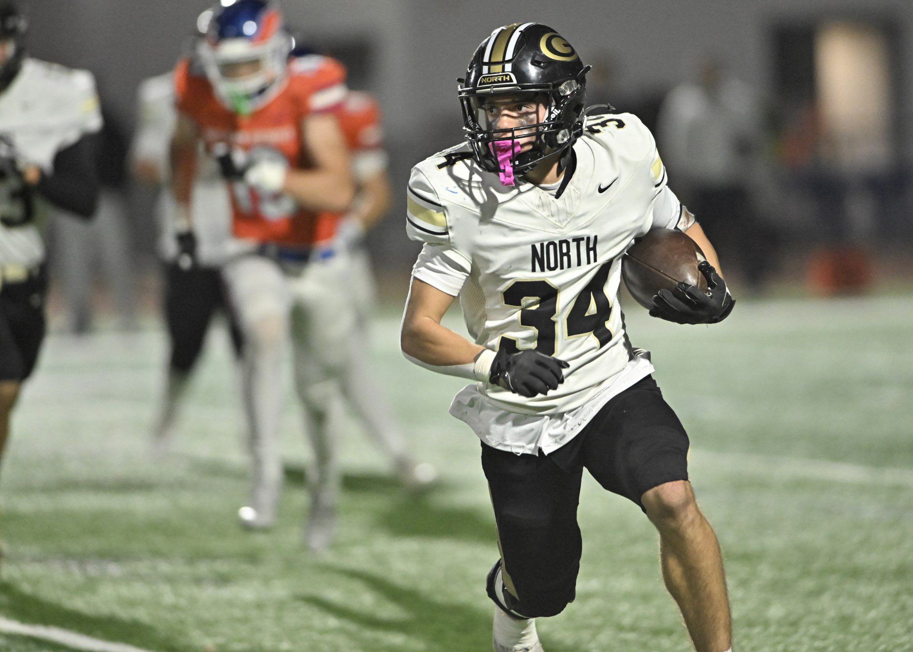 Glenbard Northâs Angelo Gatses runs against Hoffman Estates in an...