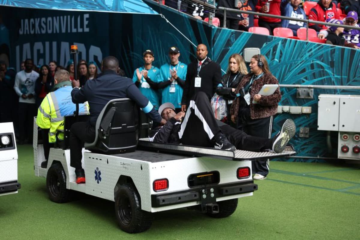 Umpire Larry Smith leaves the field on a medical buggy after suffering an injury.