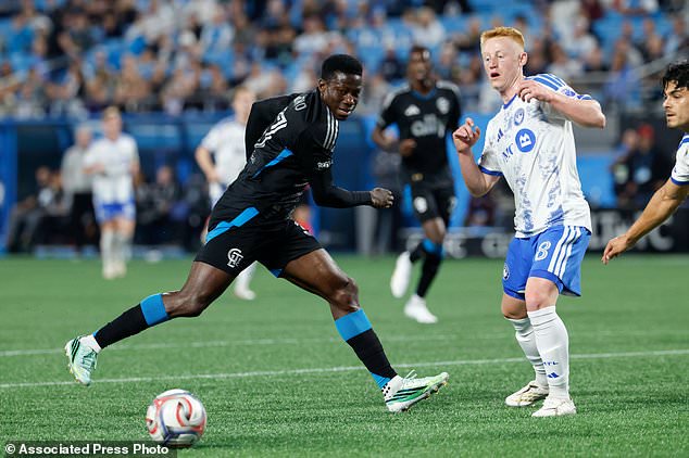 Charlotte FC forward Rodolfo Aloko, left, and CF Montreal midfielder Matty Longstaff (8) battle for the ball during the first half of an MLS soccer match in Charlotte, N.C., Wednesday, Oct. 28, 2026. (AP Photo/Nell Redmond)