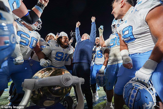 Belichick celebrates with his UNC players after winning on the road against Duke on October 17