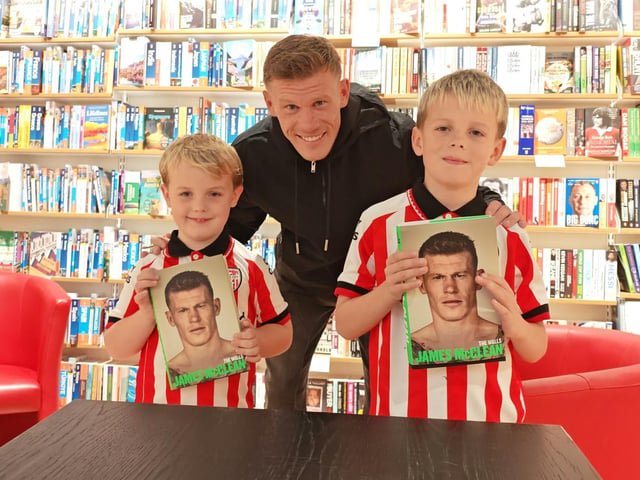 Young Derry City fans  Aodhán and Luca pose for a photograph with James McClean.