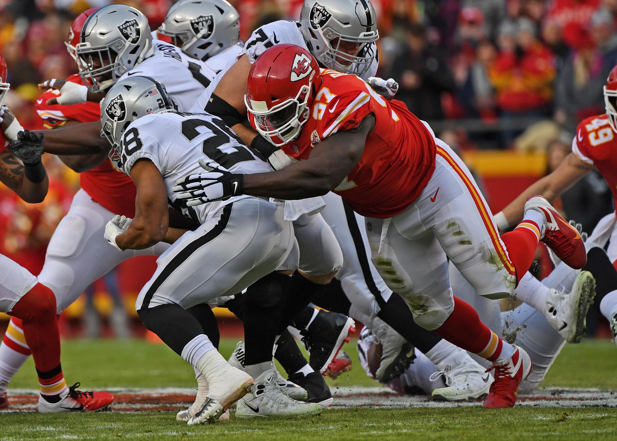 Defensive end Allen Bailey #97 of the Kansas City Chiefs tackles running back Doug Martin #28 of the Oakland Raiders during the first half at Arrowhead Stadium on December 30, 2018 in Kansas City, Missouri.  