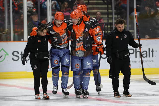 BIG BLOW: Sheffield Steelers' forward Mikko Juusola (second left) is escorted from the ice by team-mates and medical staff after taking a hit during the 6-3 win over Elite League rivals Fife Flyers on Sunday evening. Picture: Hayley Roberts/Steelers Media.