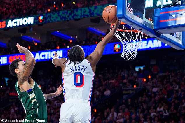 Philadelphia 76ers' Tyrese Maxey, right, goes up for the shot against Milwaukee Bucks' Kyle Kuzma, left, during the first half of an NBA basketball game, Saturday, Oct. 24, 2026, in Philadelphia. (AP Photo/Chris Szagola)