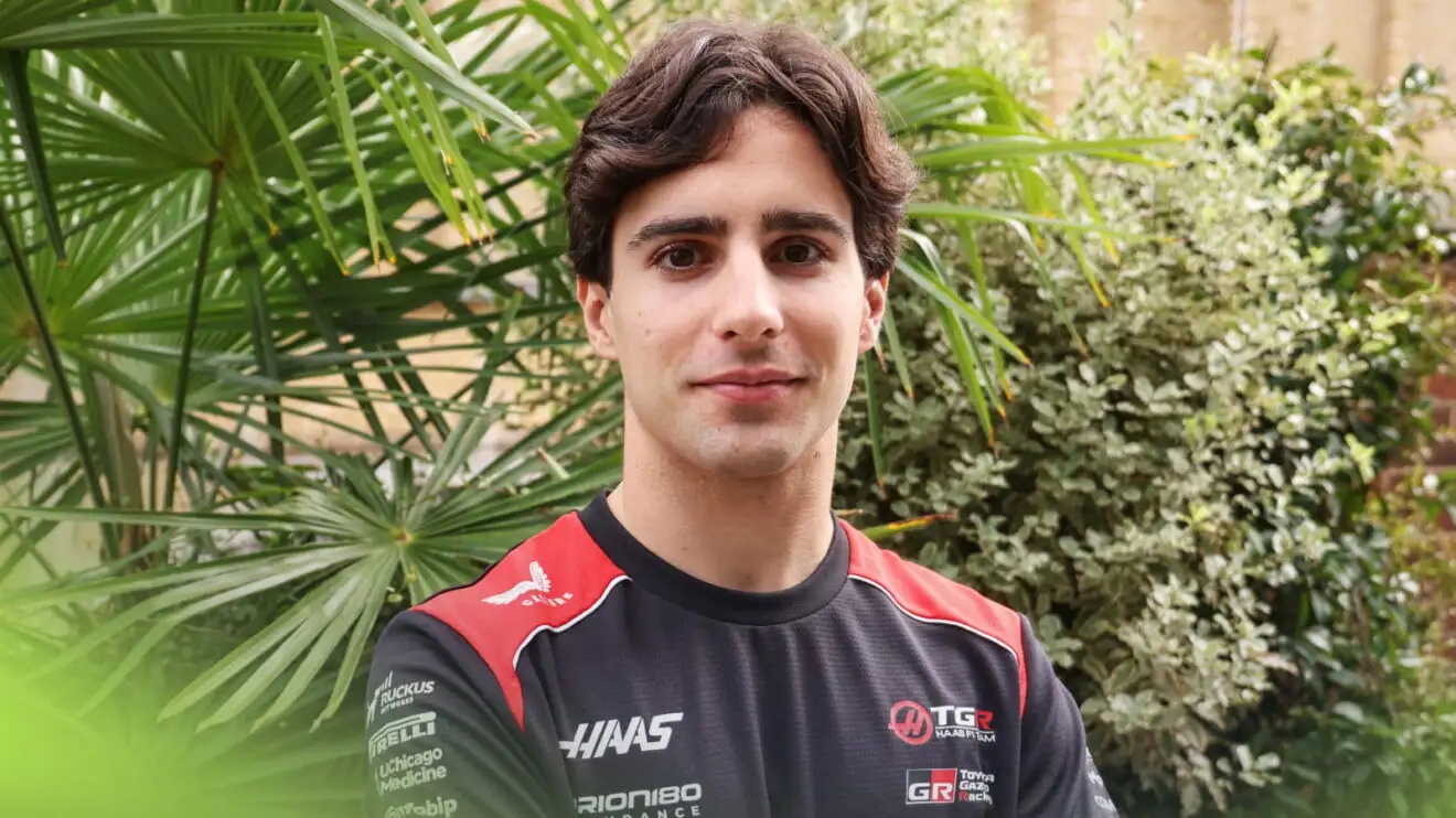 Rafael Camara wearing a Haas t-shirt with green bushes in the background