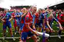 Elise Hughes of Crystal Palace Women celebrates holds aloft the Barclays Women's Championship trophy with her team mates after winning the Barclays...