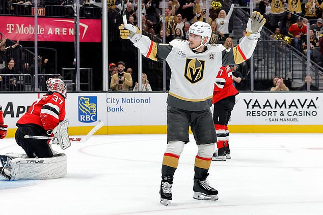 Vegas Golden Knights left wing Ivan Barbashev (49) celebrates after scoring past New Jersey Devils goaltender Connor Hellebuyck (37) during the first period of an NHL hockey game Friday, Oct. 30, 2026, in Las Vegas. (Steve Marcus/Las Vegas Sun via AP)