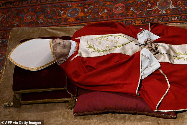In line with tradition, Benedict lay in state inside St Peter's Basilica (above, January 2023) and was then buried in a crypt underneath the building
