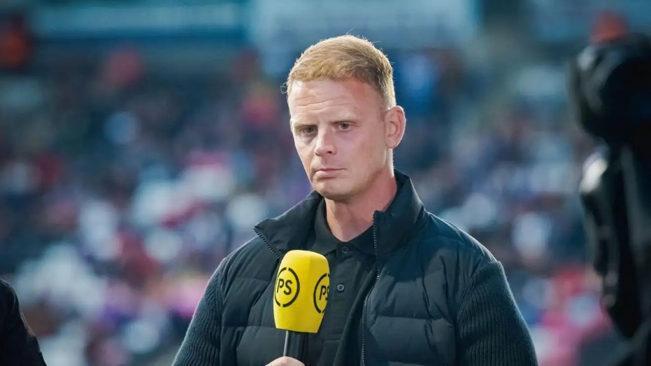 Pundit Kevin Brown pictured with a microphone in hand during a Premier Sports broadcast