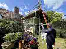 Dr Andrew Jones pictured in his garden where essential works to the roof are taking place