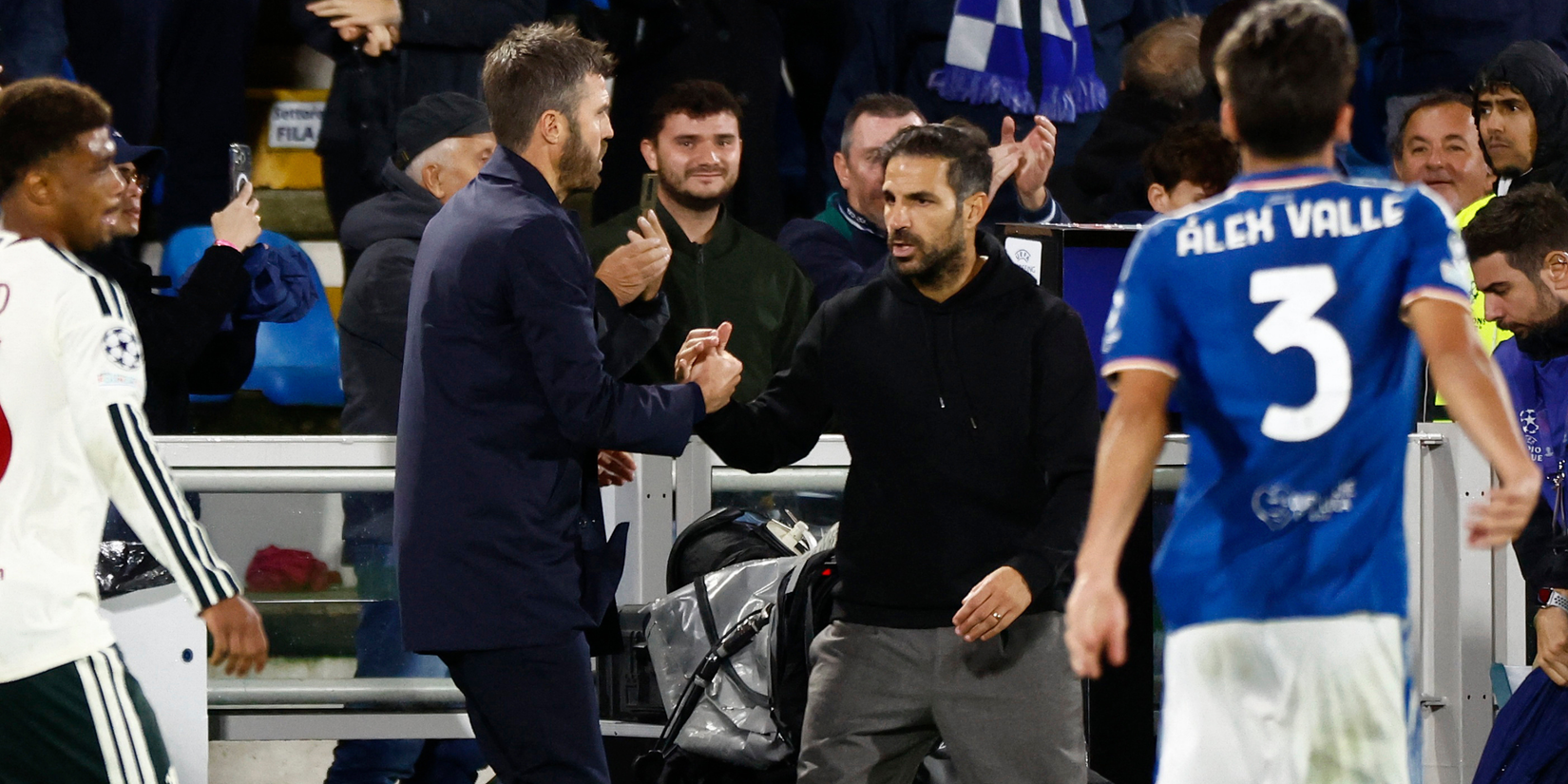Como coach Cesc Fabregas shakes hands with Manchester United manager Michael Carrick after the match