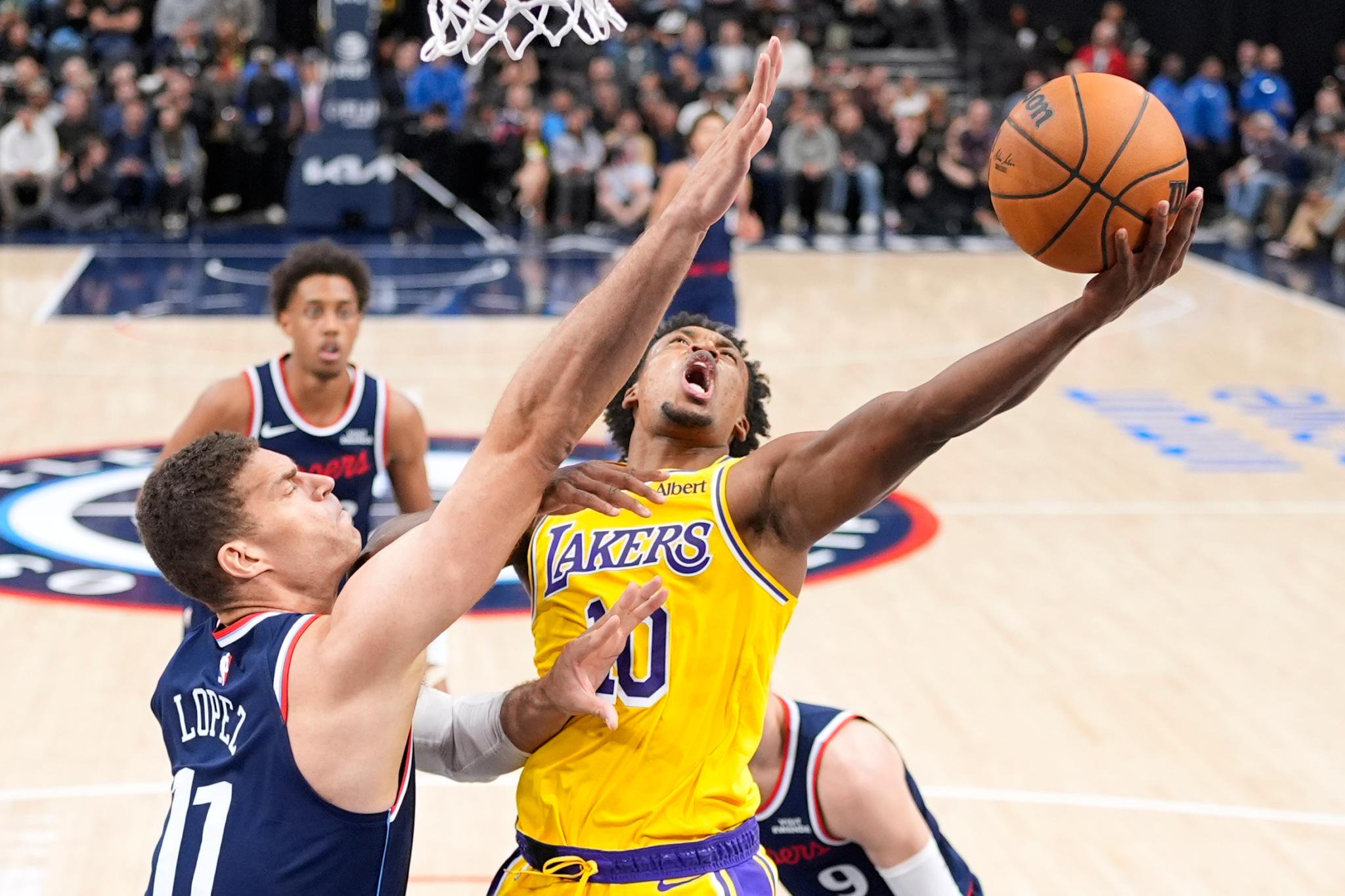 Los Angeles Lakers guard Collin Sexton shoots as Los Angeles Clippers center Brook Lopez defends during an NBA basketball game.