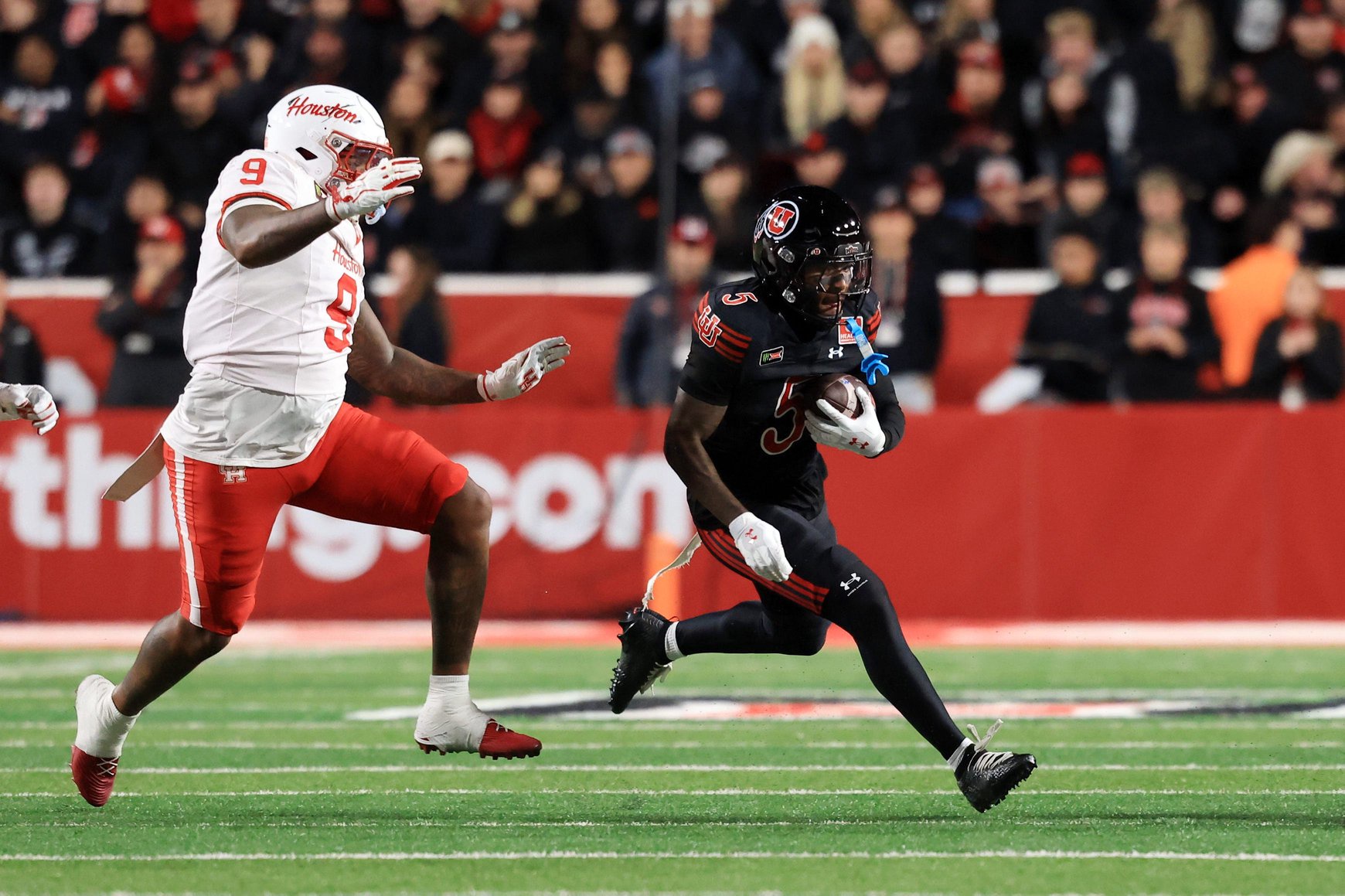 Oct 24, 2026; Salt Lake City, Utah, USA;  Utah Utes running back Daniel Bray (5) rushes as Houston Cougars defensive lineman Ashton Porter (9) defends during the second quarter at Rice-Eccles Stadium.  Mandatory Credit: Rob Gray-Imagn Images