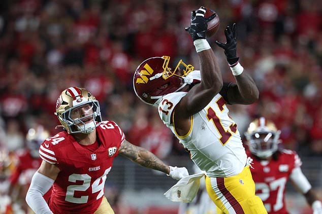 Washington Commanders wide receiver Treylon Burks (13) catches a pass against San Francisco 49ers safety Ashtyn Davis (24) during the second half of an NFL football game in Santa Clara, Calif., Monday, Oct. 19, 2026. (AP Photo/Jed Jacobsohn)