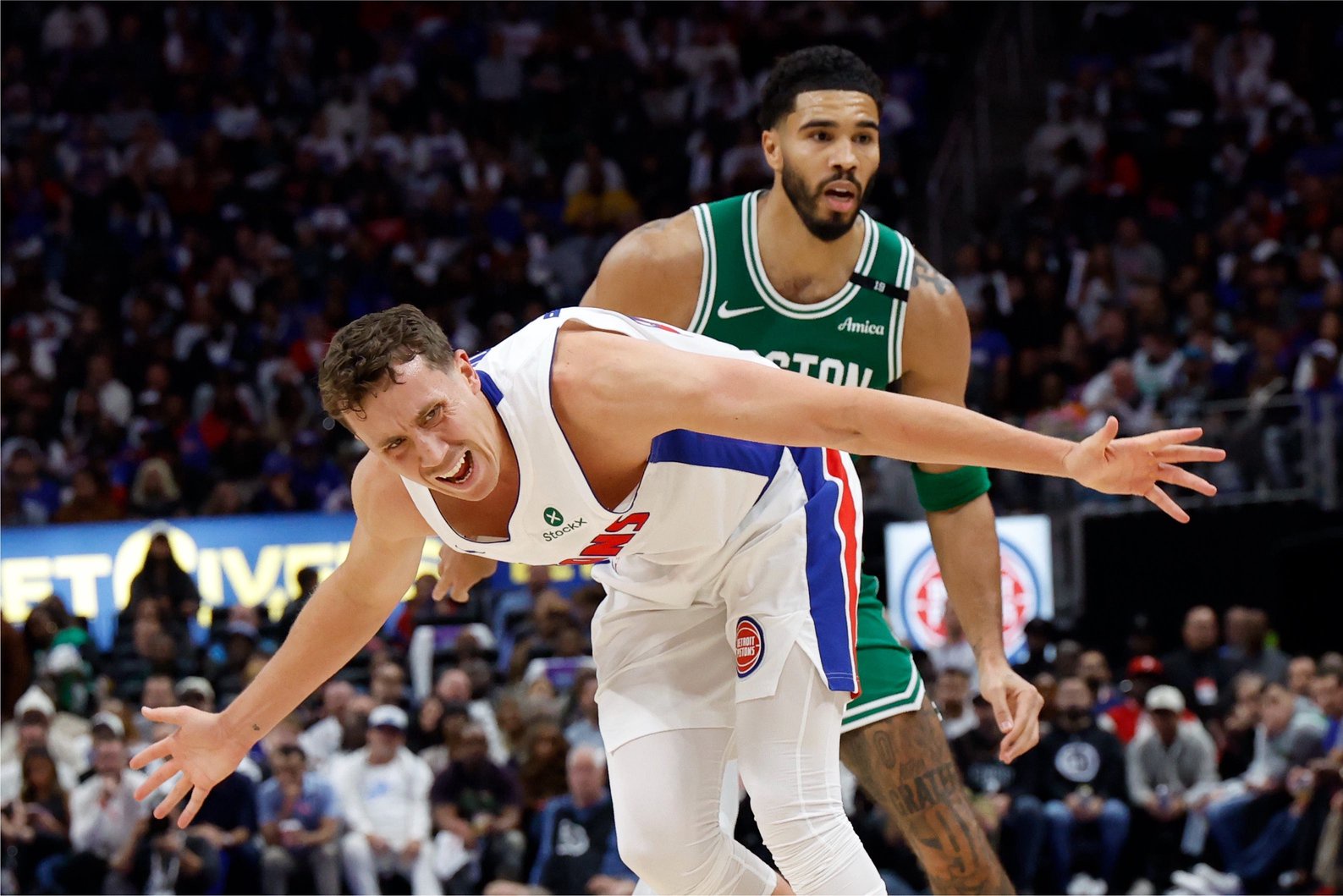 Oct 20, 2026; Detroit, Michigan, USA;  Detroit Pistons forward Duncan Robinson (55) is fouled by Boston Celtics forward-guard Jayson Tatum (0) in the first half at Little Caesars Arena.  Mandatory Credit: Rick Osentoski-Imagn Images