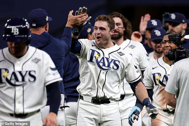 Williamson celebrates with his teammates after his game-winning hit