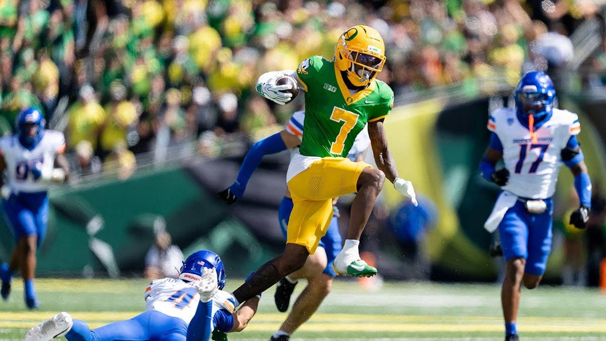 Evan Stewart being tackled during a college football game