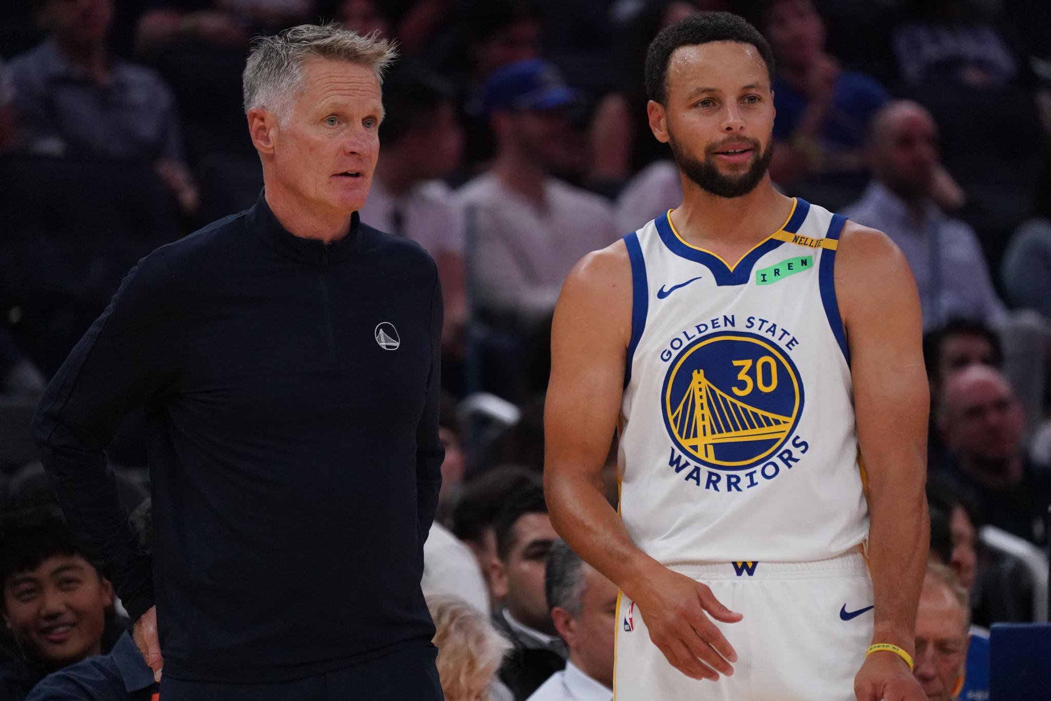 Golden State Warriors head coach Steve Kerr and guard Stephen Curry talk during a break against the Portland Trail Blazers.