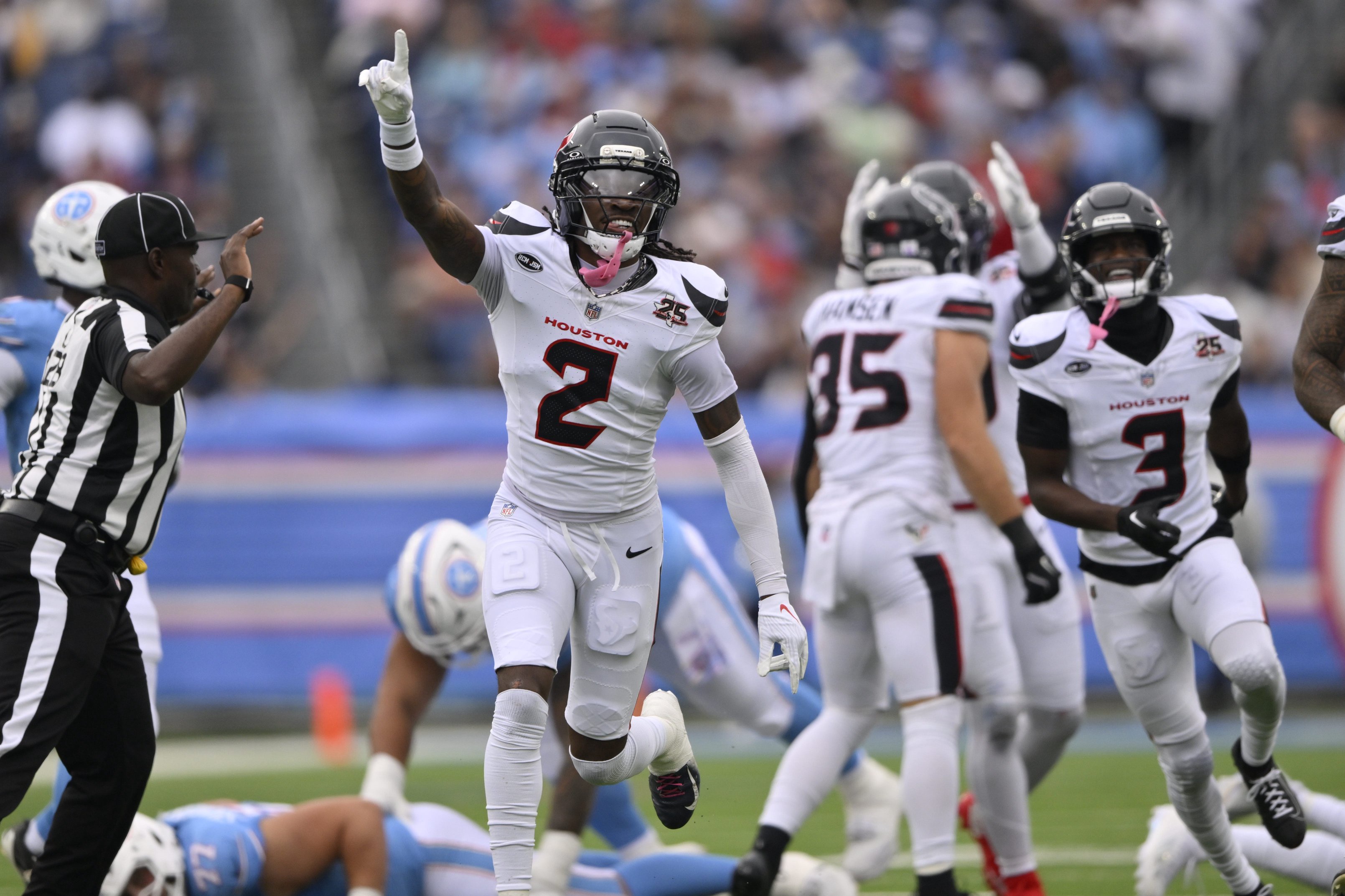 Oct 11, 2026; Nashville, Tennessee, USA;  Houston Texans safety Calen Bullock (2) celebrates a fumble by Houston Texans safety Jalen Pitre (5) during the first half at Nissan Stadium.  Mandatory Credit: Steve Roberts-Imagn Images