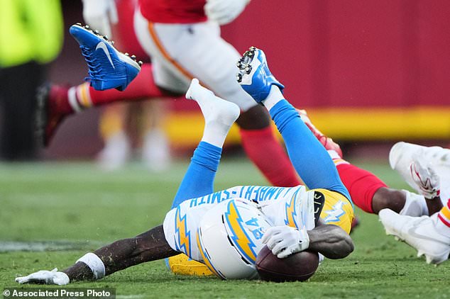 Los Angeles Chargers wide receiver Keandre Lambert-Smith (84) loses his cleat as he dives forward attempting to reach for a first down after making a catch during the second half of an NFL football game against the Kansas City Chiefs in Kansas City, Mo., Sunday, Oct. 18, 2026. (AP Photo/Charlie Riedel)