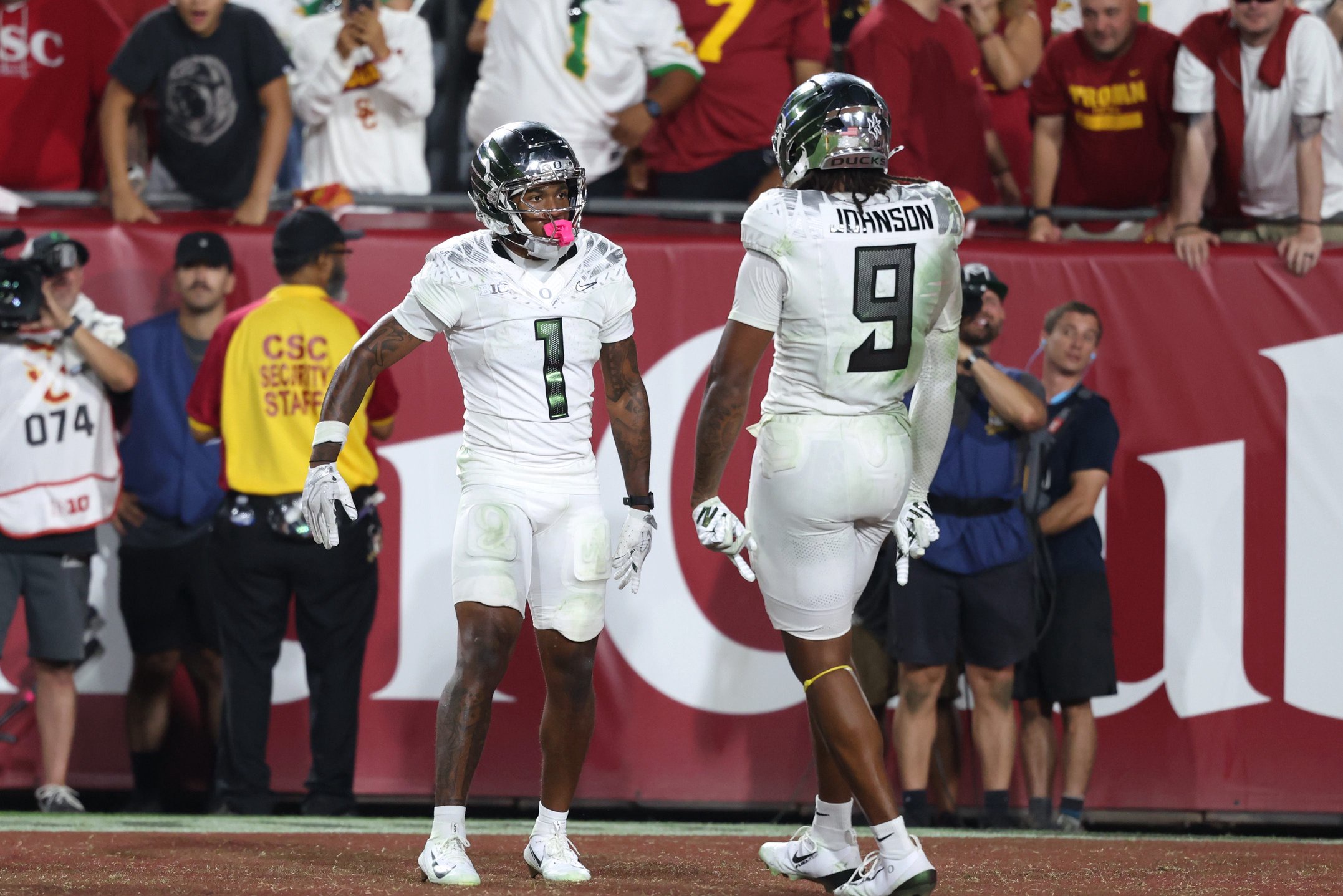 Sep 26, 2026; Los Angeles, California, USA;  Oregon Ducks wide receiver Dakorien Moore (1) celebrates with tight end Jamari Johnson (9) after scoring a touchdown against the USC Trojans during the fourth quarter at United Airlines Field at Los Angeles Memorial Coliseum.  Mandatory Credit: Kiyoshi Mio-Imagn Images