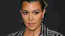 Kourtney Kardashian wearing a striped blazer 
